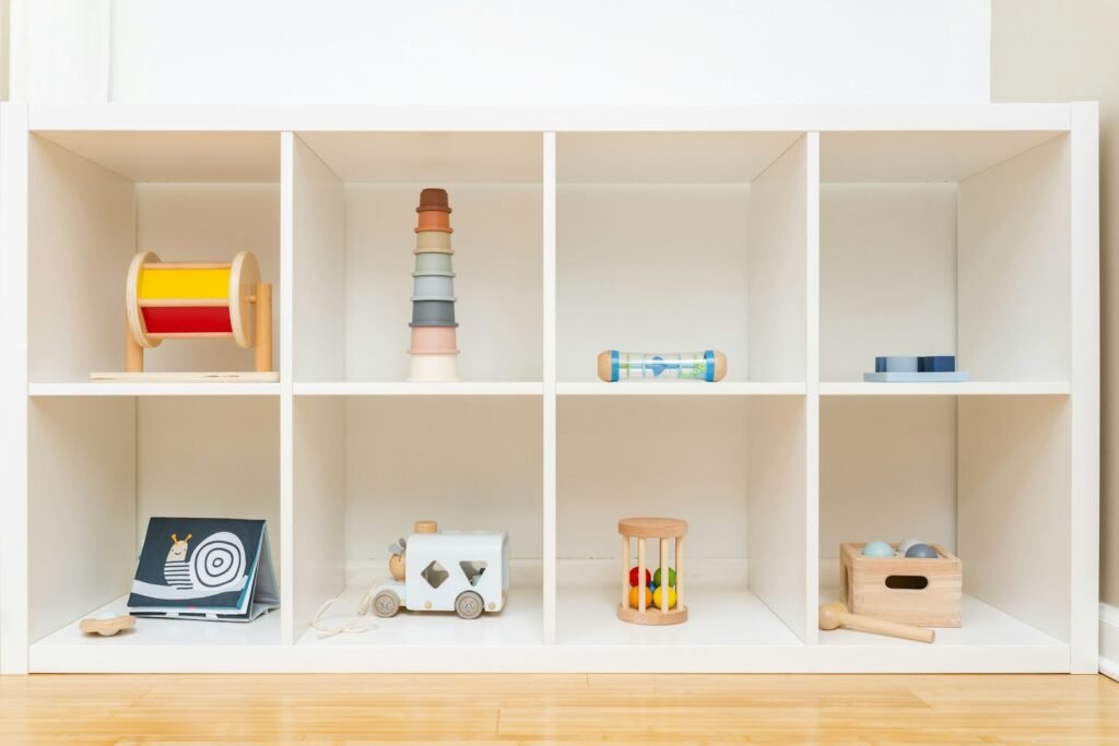 Low wooden shelf with neatly arranged learning materials for children